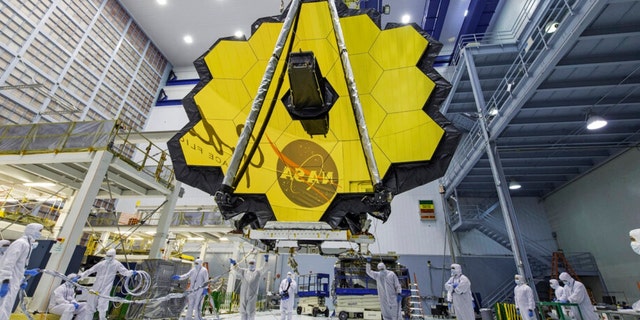 In this April 13, 2017, photo provided by NASA, technicians lift the mirror of the James Webb Space Telescope using a crane at the Goddard Space Flight Center in Greenbelt, Maryland.